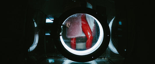 a woman in red stockings is reflected in a mirror