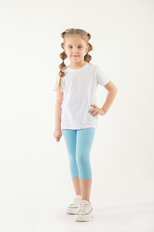 a little girl standing with her hands on her hips