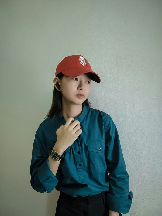 a woman in a blue shirt and a red hat
