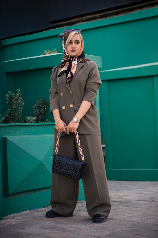 a woman in a brown suit and a black purse